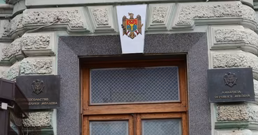 The entrance of a Moldovan embassy building with the national coat of arms.
