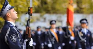 Moldovan soldiers in uniform standing in formation during a ceremony.