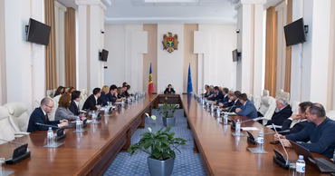 Anna Groza presiding over a formal meeting of the National Confederation of Employers of Moldova.