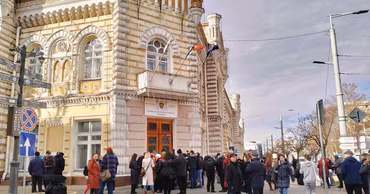 People standing in front of the Chisinau City Hall building.