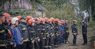Moldovan emergency responders in uniform standing in a line during a briefing.