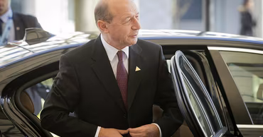 Former Romanian President Traian Basescu stepping out of a car.