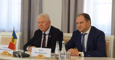 Ion Ceban sitting at a table during an official meeting.
