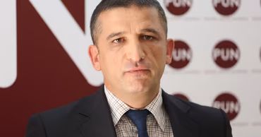 A portrait of Vlad Turcanu in a suit.