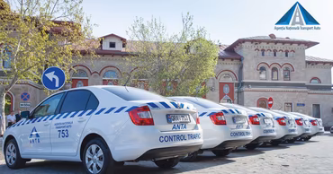 A row of white ANTA patrol cars parked in front of a building in Moldova.