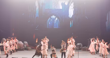 Lupii lui Calancea band performing on stage with dancers in traditional Moldovan clothing.