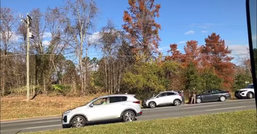 Cars parked on the side of a road at the scene of a traffic accident.