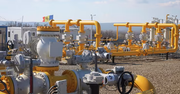 Gas pipeline infrastructure with a Moldovan flag in the background.