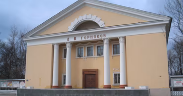 A classic Soviet-style House of Culture building with columns and a pediment.