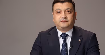 Portrait of Adrian Efros, Minister of Internal Affairs of Moldova, in a suit.