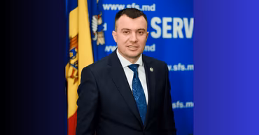 Portrait of Adrian Gavrilita in front of the Moldovan flag and State Tax Service logo.