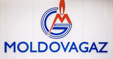 The official logo of the Moldovagaz company displayed on a wall.