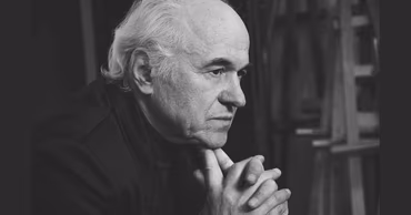 A black and white portrait of the Moldovan composer Eugen Doga.
