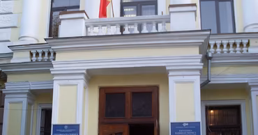 The main entrance of the Technical University of Moldova building with the national flag.