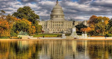 The United States Capitol building in Washington D.C. reflected in the water.