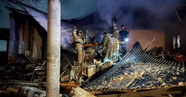 Moldovan firefighters working at the site of a destroyed house after a gas explosion.