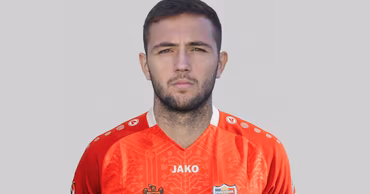 Portrait of Moldovan football player Victor Bogaciuc wearing the national team jersey.