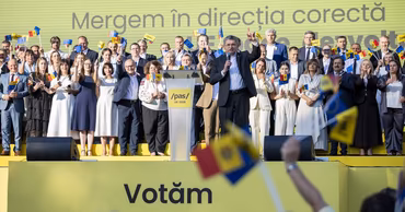 Igor Grosu speaking at a PAS party event with supporters holding flags.