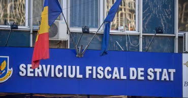 The facade of the State Tax Service building in Moldova with the national flag.