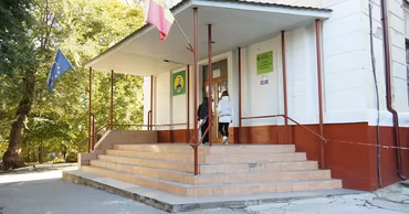 Entrance to the Alexei Mateevici College in Chisinau with students entering the building.