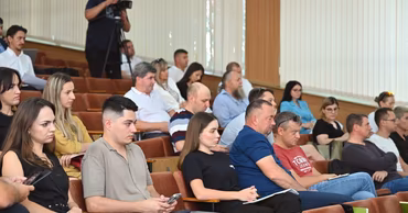 People sitting in an auditorium attending a public presentation or meeting in Chisinau.
