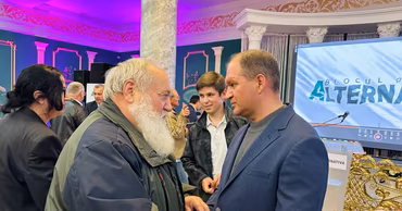 Ion Ceban talking to a man at a MAN party event.