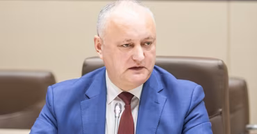 Igor Dodon sitting at a table during a meeting or press conference.