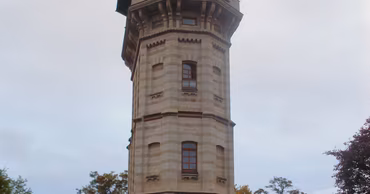 The historic Water Tower in Chisinau, Moldova, surrounded by trees.