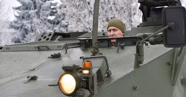 A Moldovan soldier in a military vehicle during winter training.