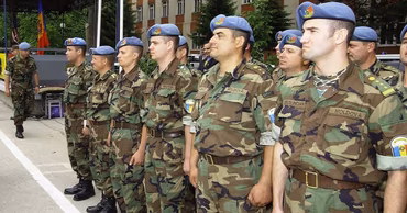 A group of Moldovan soldiers in uniform standing in formation during a ceremony.
