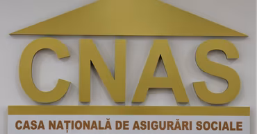 The logo of the National Social Insurance House of Moldova (CNAS) on a wall.