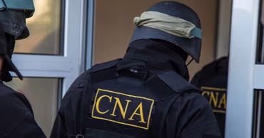 CNA officers in tactical gear during an operation.