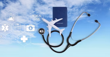 A stethoscope, a toy airplane, and a passport against a blue sky background.