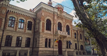 The Ministry of Culture building in Chisinau, Moldova, with national and EU flags.