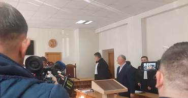 A courtroom scene with a judge and legal personnel present during a hearing.
