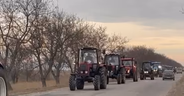 A convoy of tractors driving on a road during a farmers protest in Moldova.