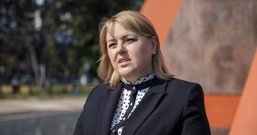 Portrait of Moldovan politician Irina Lozovan outdoors.