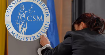 A person cleaning the official logo of the Superior Council of Magistracy (CSM) in Moldova.