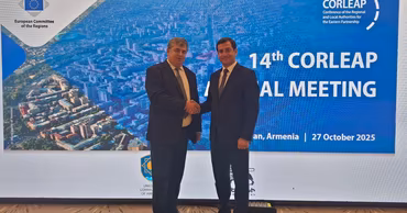 Constantin Cojocaru shaking hands at a CORLEAP meeting.