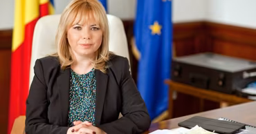 Anca Dragu, Governor of the National Bank of Moldova, sitting at her office desk.