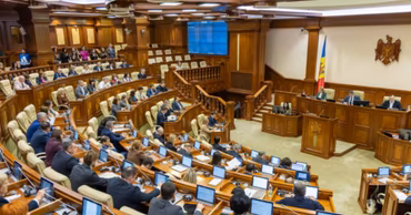 A wide-angle view of the Moldovan Parliament session hall with deputies at their desks.