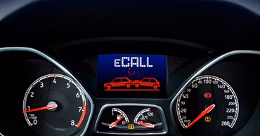 A car dashboard display showing an eCall notification with a collision icon.