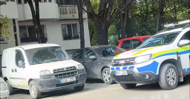 A Moldovan police vehicle parked on a street in Chisinau near residential buildings.