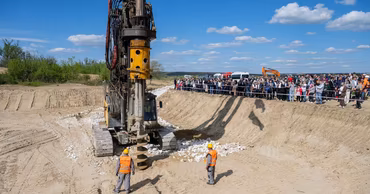 Construction machinery and workers at the site of the Ungheni bridge project.