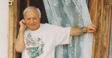 Portrait of Moldovan writer Vasile Vasilache standing in a doorway.