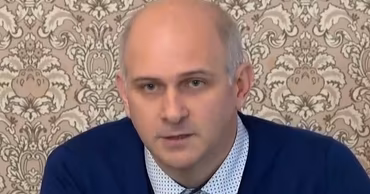 Vasile Tofan speaking at a press conference or event.