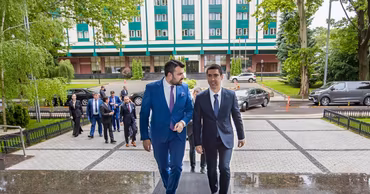 Minister Gheorghe Hajder walking outside a government building in Chisinau.