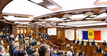 A wide shot of the Moldovan Parliament plenary hall during a session.
