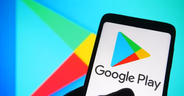 A smartphone displaying the Google Play logo with a large background logo.