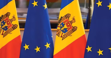 Flags of Moldova and the European Union standing side by side.